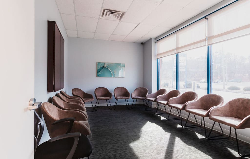 a row of chairs in a mental health center near New Jersey with large windows