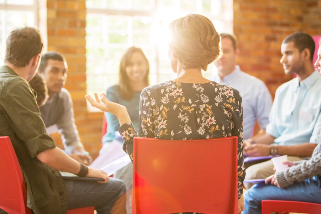 a group of people sitting around each other at a Mental Health Center Near New Jersey