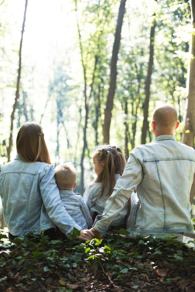 a group of people sitting on a bench in the woods, reflecting on their mental health support and treatment options available in New Jersey