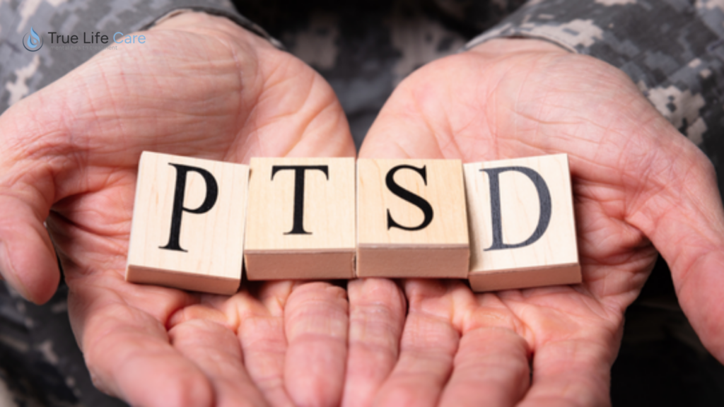Hands holding blocks spelling PTSD